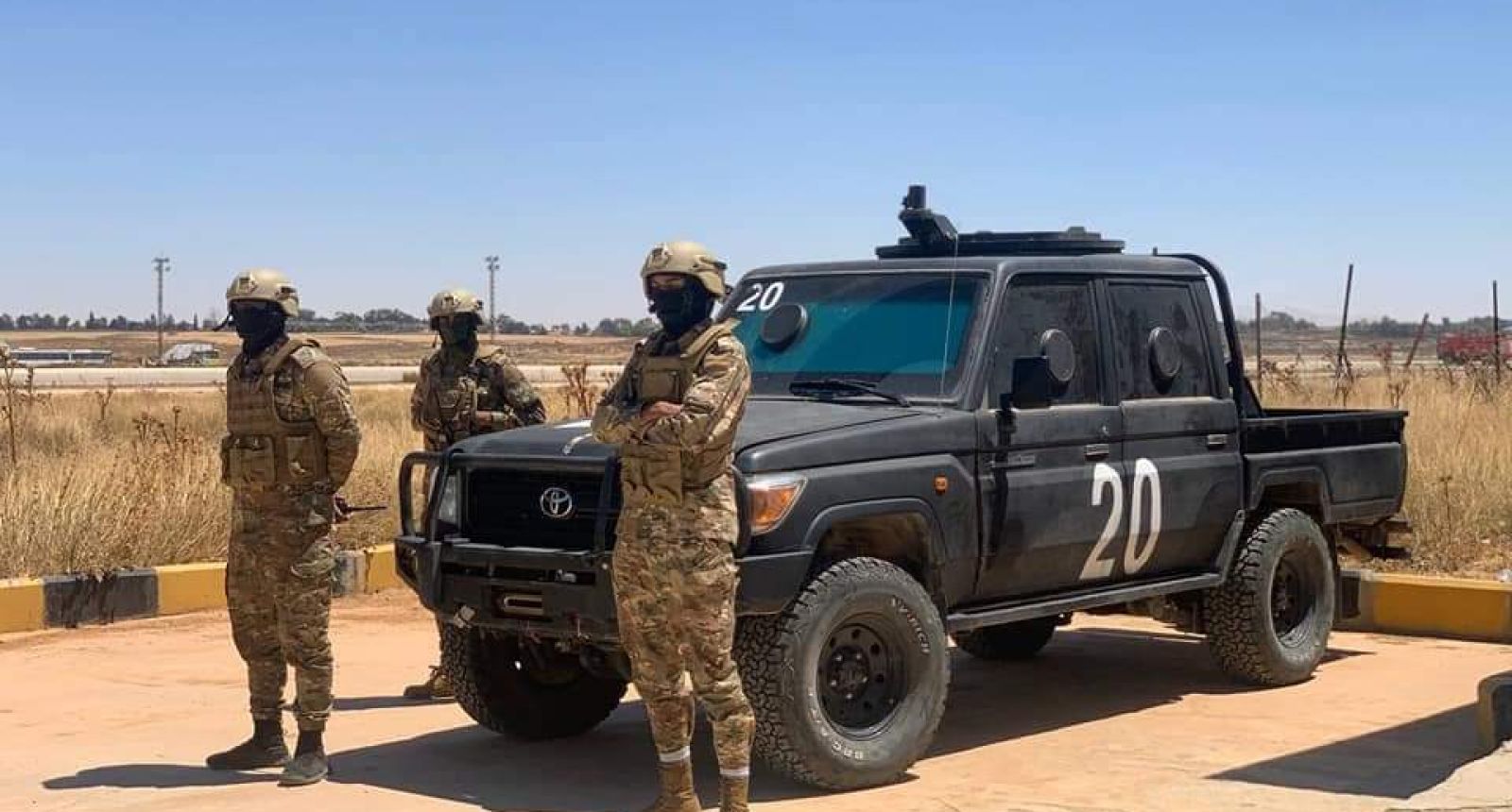 a group of people in military uniforms standing in front of a truck